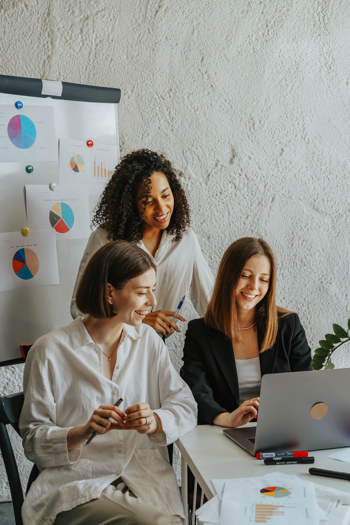 HR team reviewing reports on a laptop